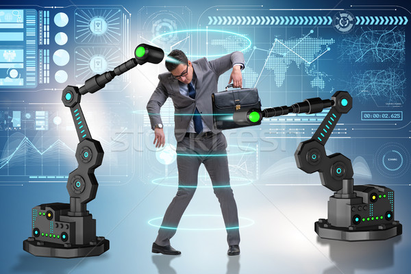 Businessman being manipulated by robotic arms Stock photo © Elnur