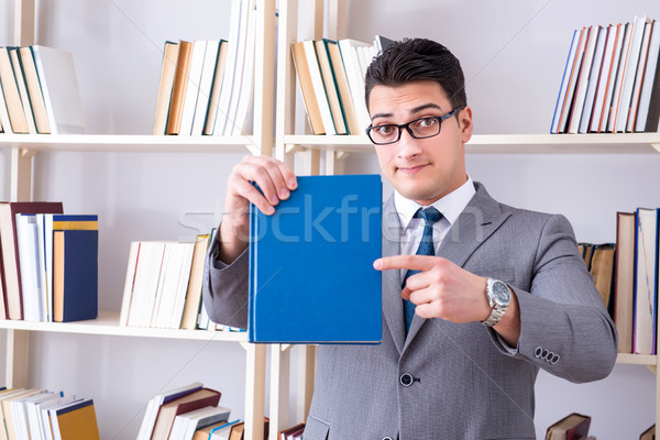 Businessman student reading a book studying in library Stock photo © Elnur