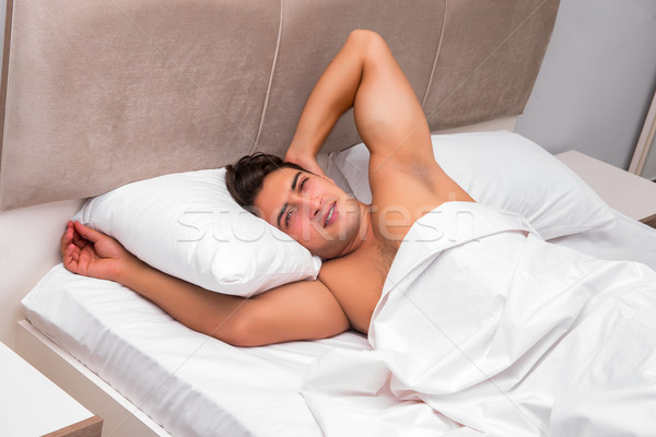 Stock photo: Man having trouble waking up in the morning