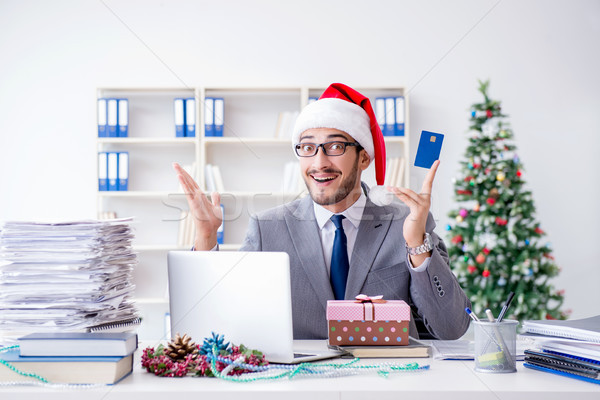 Young businessman celebrating christmas in the office Stock photo © Elnur