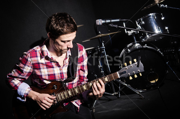 Stock photo: Man playing guitar during concert