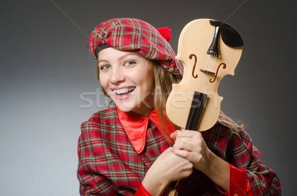 Woman in scottish clothing in musical concept Stock photo © Elnur