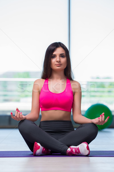 Young woman meditating in gym health concept Stock photo © Elnur