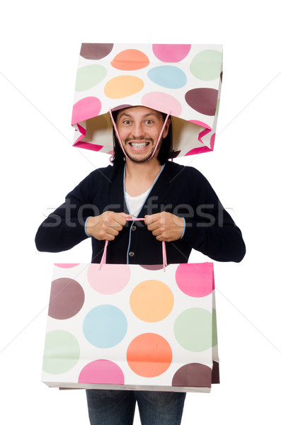 Young man holding plastic bags isolated on white Stock photo © Elnur