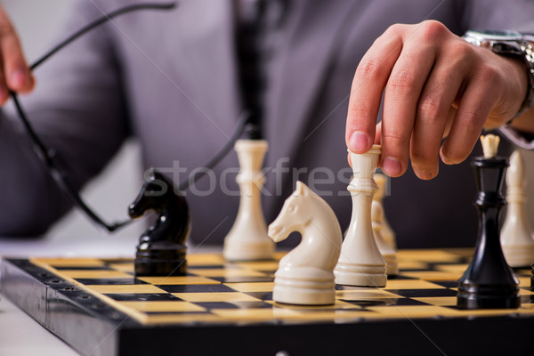 Young businessman playing chess in the office Stock photo © Elnur
