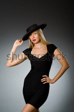 Woman with gun against dark background Stock photo © Elnur