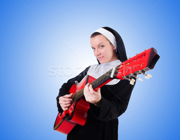 Nun playing guitar against the gradient  Stock photo © Elnur