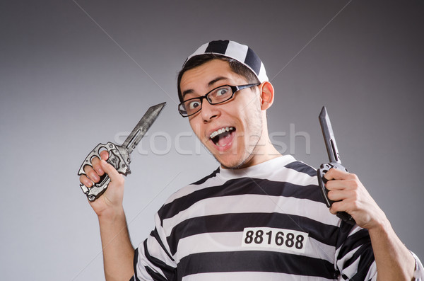 Funny prisoner with knuckles isolated on gray Stock photo © Elnur