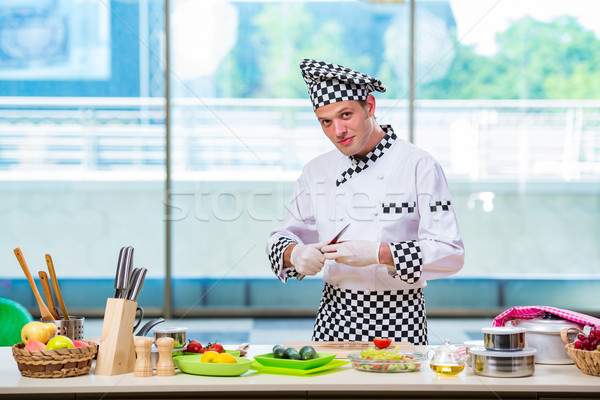 Stock photo: Male cook preparing food in the kitchen
