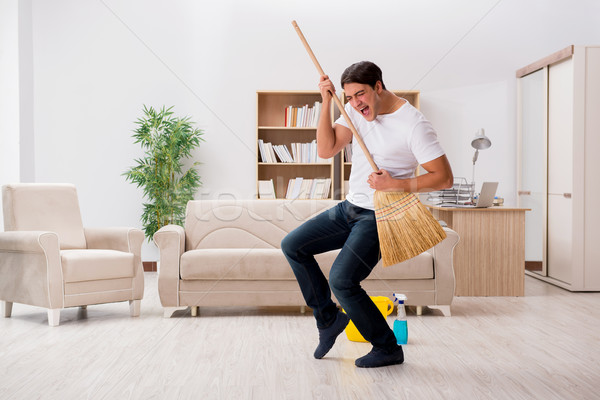 Homem limpeza casa vassoura guitarra indústria Foto stock © Elnur