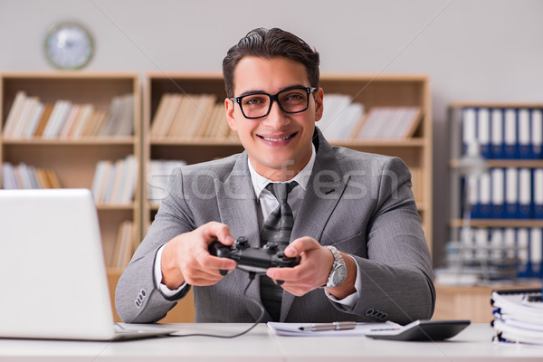 Businessman playing computer games at work office Stock photo © Elnur