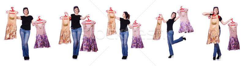 Stock photo: Woman trying to choose dress on white