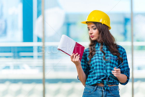 Woman builder taking notes at construction site Stock photo © Elnur