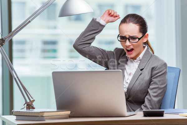 Businesswoman sitting at her desk in business concept Stock photo © Elnur