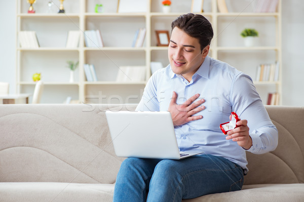 The young man making marriage proposal over internet laptop Stock photo © Elnur