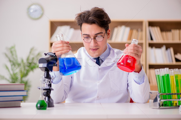 Mad crazy scientist doctor doing experiments in a laboratory Stock photo © Elnur