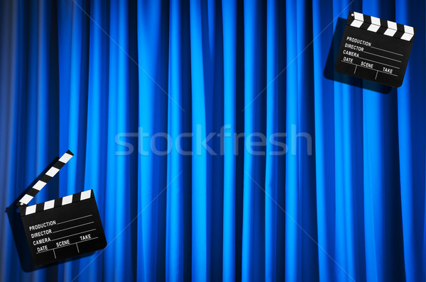 Stock photo: Movie clapper board against curtain