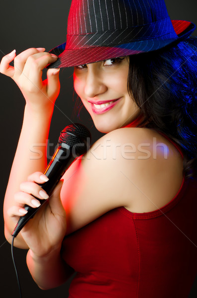 Female performer at disco with mic Stock photo © Elnur