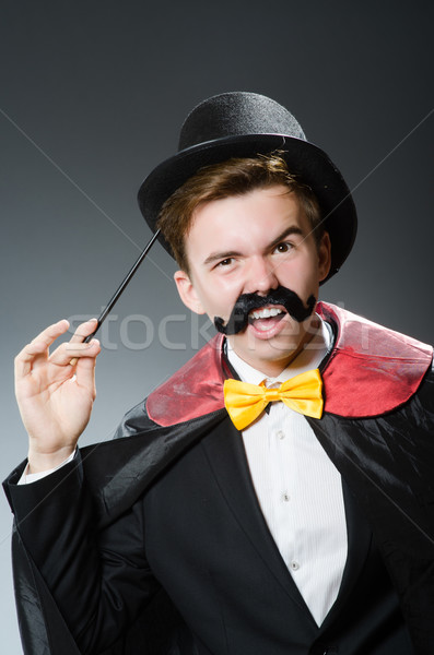 Stock photo: Funny magician with wand and hat