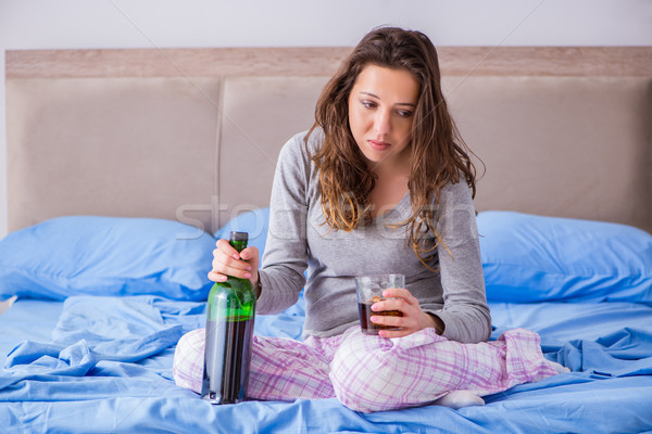 Young woman drinking alcohol depressed at home Stock photo © Elnur