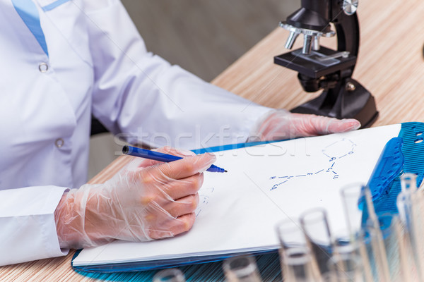 Young student working with chemical solutions in lab Stock photo © Elnur