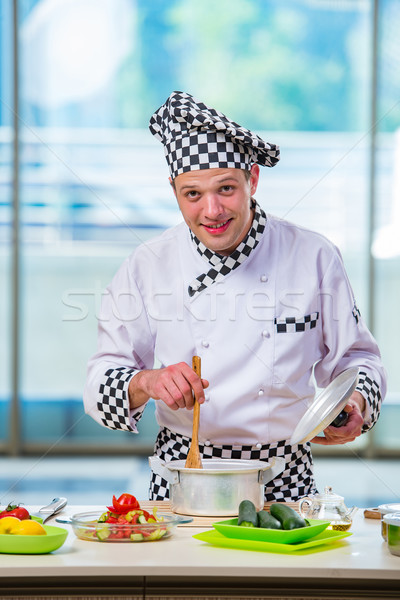 Male cook preparing food in the kitchen Stock photo © Elnur