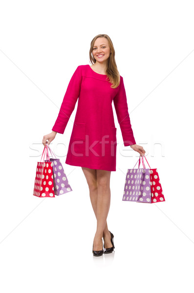 Shopper girl in pink dress holding plastic bags isolated on whit Stock photo © Elnur