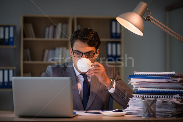 Businessman staying in the office for long hours Stock photo © Elnur