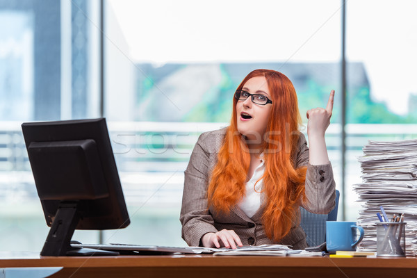 Stressed businesswoman with stack of papers Stock photo © Elnur