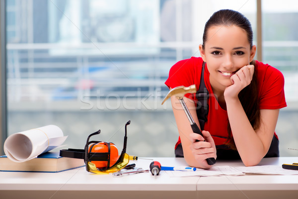 Young woman in coveralls doing repairs Stock photo © Elnur
