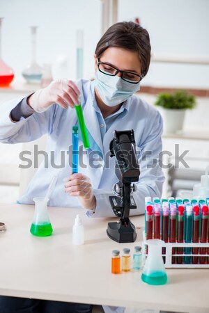 The male doctor working in the lab on virus vaccine Stock photo © Elnur