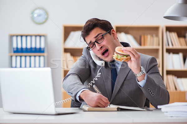 Hungry funny businessman eating junk food sandwich Stock photo © Elnur