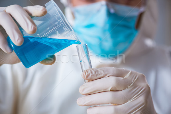 Young chemist student working in lab on chemicals Stock photo © Elnur