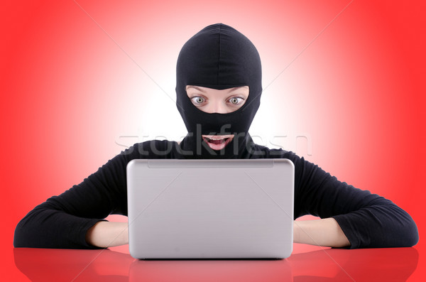 Stock photo: Hacker with computer wearing balaclava