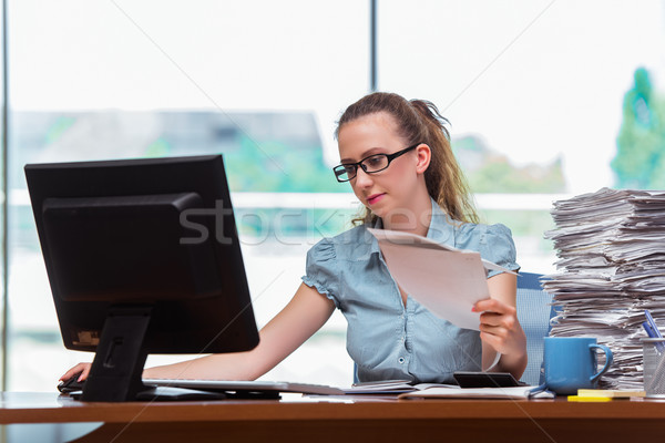 Stressed businesswoman with stack of papers Stock photo © Elnur