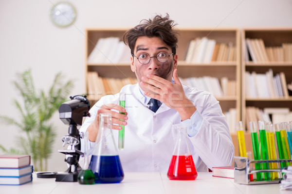 Mad crazy scientist doctor doing experiments in a laboratory Stock photo © Elnur