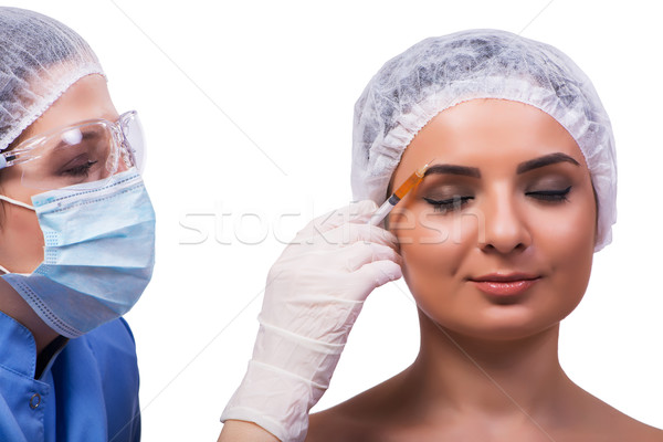 Young woman preparing for injection of botox isolated on white Stock photo © Elnur