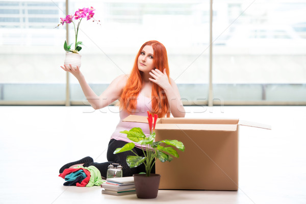 Young woman moving house in lifestyle concept Stock photo © Elnur