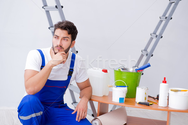 Repairman doing renovation repair in the house with paper wallpa Stock photo © Elnur