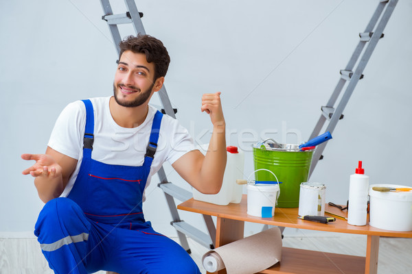 Repairman doing renovation repair in the house with paper wallpa Stock photo © Elnur