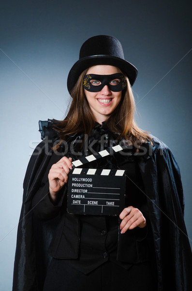 Woman wearing mask with movie board Stock photo © Elnur