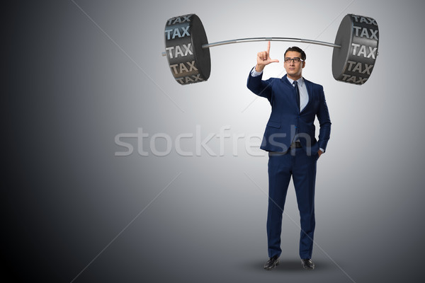 Businessman under  heavy burden of taxes Stock photo © Elnur