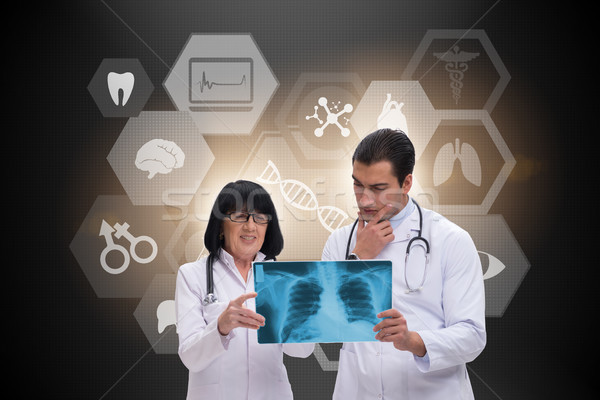 Two doctors discussing x-ray image in telemedicine concept Stock photo © Elnur