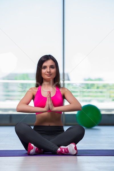 Young woman meditating in gym health concept Stock photo © Elnur