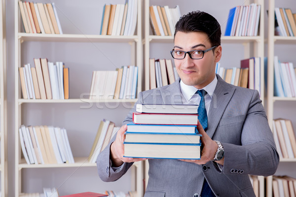 Business law student with pile of books working in library Stock photo © Elnur