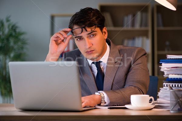 Businessman staying in the office for long hours Stock photo © Elnur