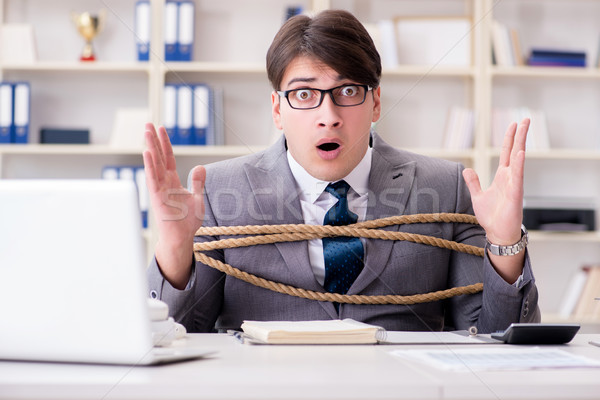 Businessman tied up with rope in office Stock photo © Elnur