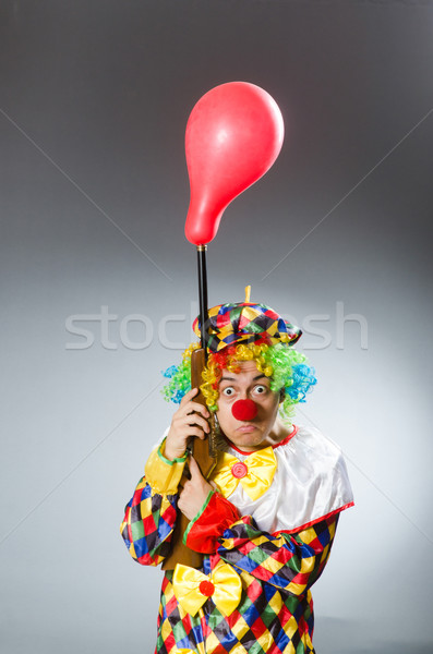 Clown with balloon and rifle in funny concept Stock photo © Elnur