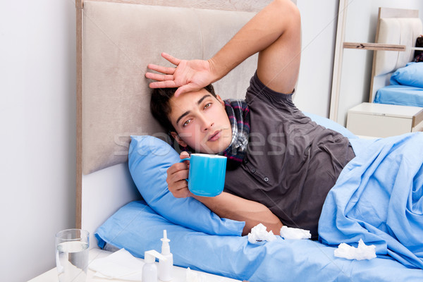 Sick ill man in the bed taking medicines and drugs Stock photo © Elnur
