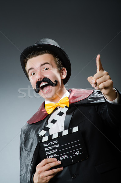 Funny man with movie clapper board Stock photo © Elnur